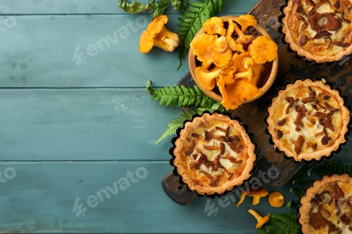 Preview: Savory hands pie with chanterelle mushrooms, cream and cheese on cutting board on rustic old wooden