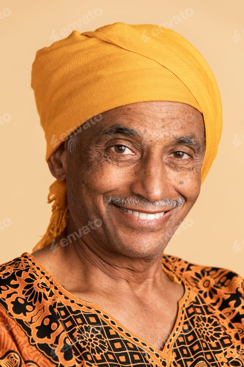 Preview: Mixed senior Indian man wearing a yellow turban