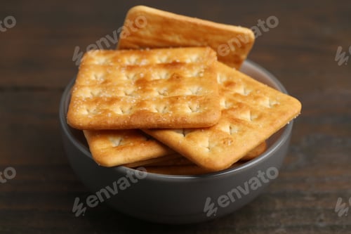 Preview: Tasty salty crackers on wooden table, closeup