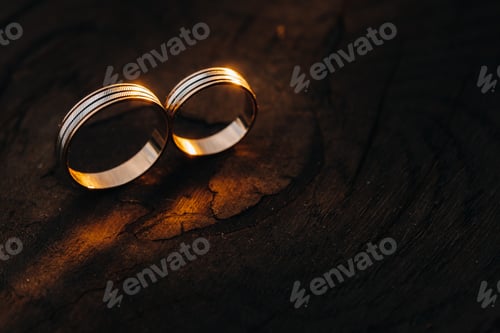 Preview: Two wedding engagement rings on a wooden base For a gold ring of a loving wedding couple.Concept of