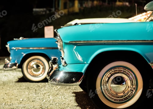 Preview: Closeup shot of a blue retro car with another old car in the background