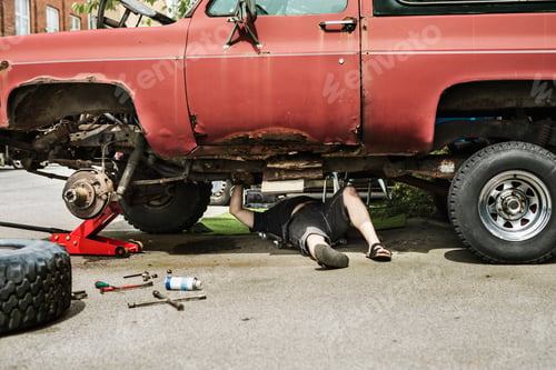 Preview: Mature man repairing car