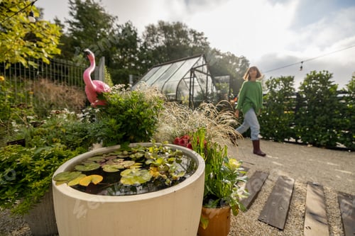 Preview: Beautiful green yard with a woman gardening