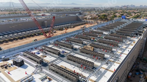Preview: Aerial view of industrial facility under construction.