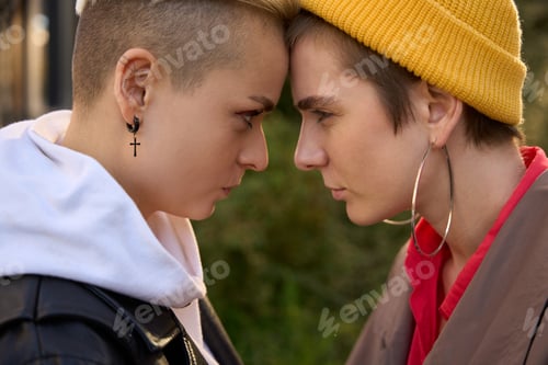 Preview: Two young women touch foreheads and look into each other's eyes