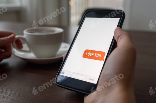 Preview: Hand holding phone with love valentine message