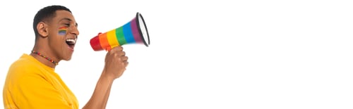 Preview: african american man with lgbt flag painted on face shouting in loudspeaker isolated on white,