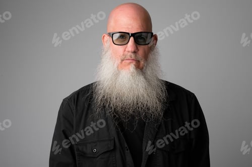 Preview: Face of mature handsome bald man with long beard wearing sunglasses