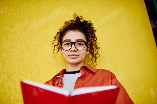 Preview: Calm woman with book doing homework