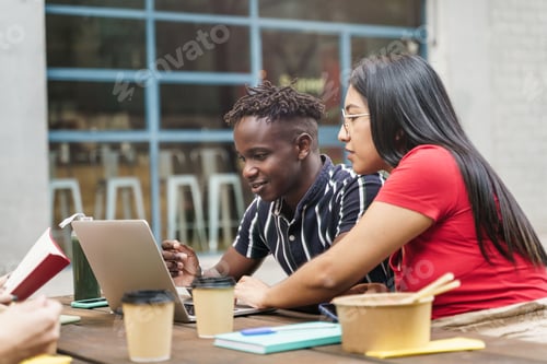 Preview: Young international coworkers working together during meal break