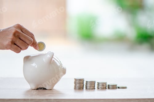 Preview: hand of man drop coin into piggy bank arranged as graph