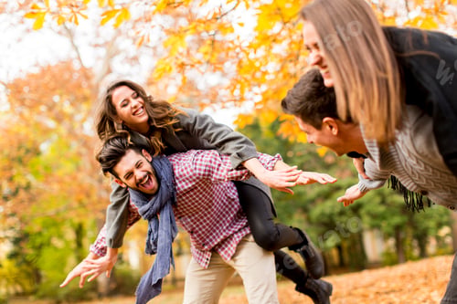 Preview: Boyfriends holding girlfriends on back in autumn park