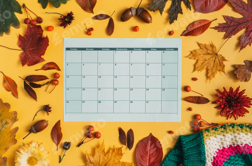 Preview: Dry leaves with a calendar in the middle with a striped jacket on a yellow background