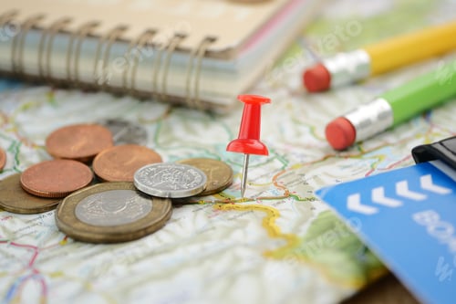 Preview: Planning a trip with coins, map, and stationery tools