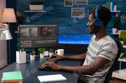 Preview: Filmmaker man editing movie footage on computer