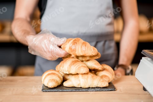 Preview: Serving croissants on the plate at the bakery