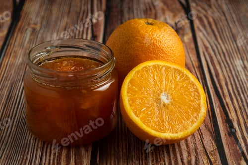 Preview: Yellow oranges with a jar of confiture