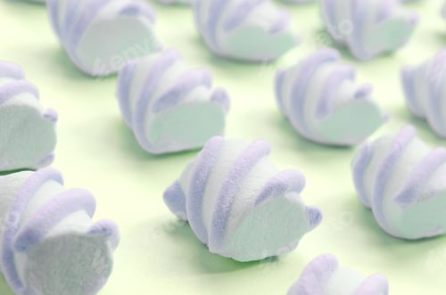 Preview: Colorful marshmallow laid out on lime paper background. pastel creative textured pattern