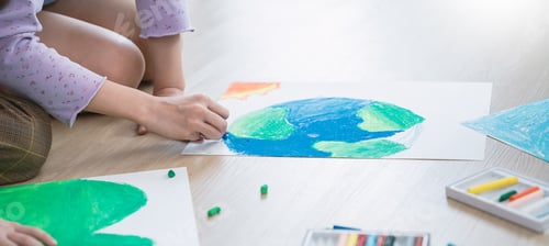 Preview: Group of kids hands drawing with crayons on the floor during an art activity in a bright classroom