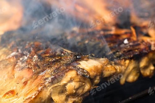 Preview: Closeup shot of deliciously prepared mackerel fish on a charcoal barbecue grill