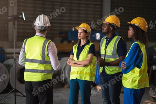 Preview: Warehouse meeting with multi-ethnic factory workers discussing production strategies
