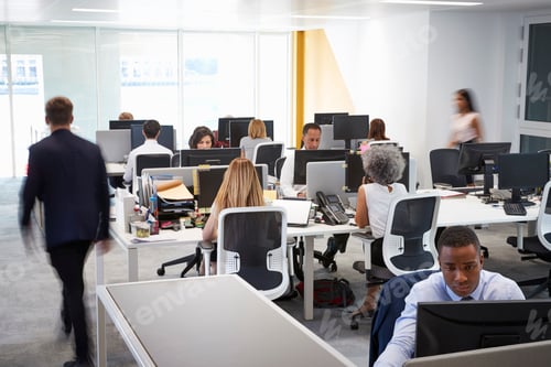 Preview: Man walking through a busy open plan office