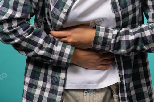 Preview: Hands of girl squeezing belly with hands. abdominal pain, suffering stomach ache