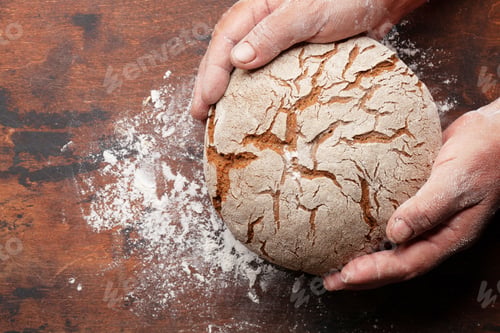 Preview: Baker holding fresh baked homemade bread