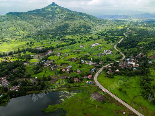Preview: Aerial view of a mountain landscape with few houses near the lake