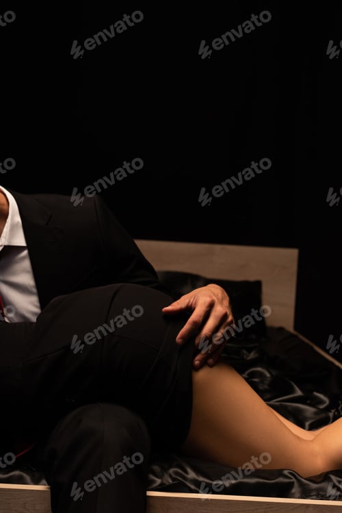Preview: cropped view of sexy couple in bed in dark room