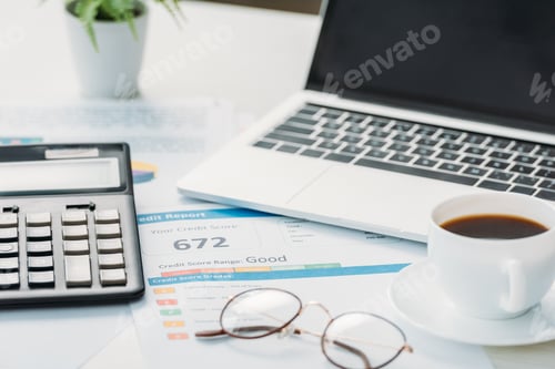 Preview: selective focus of credit report, calculator, glasses, cup with coffee and laptop