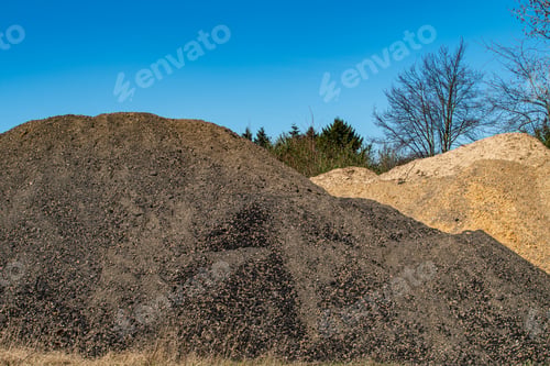 Pile of Dark Soil and Sand with Blue Sky