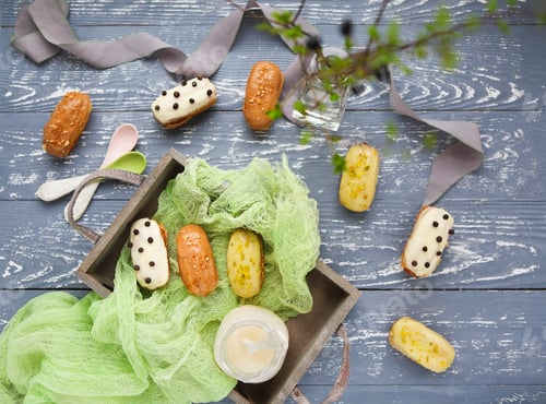 Preview: Eclairs with chocolate and whipped cream on dark background