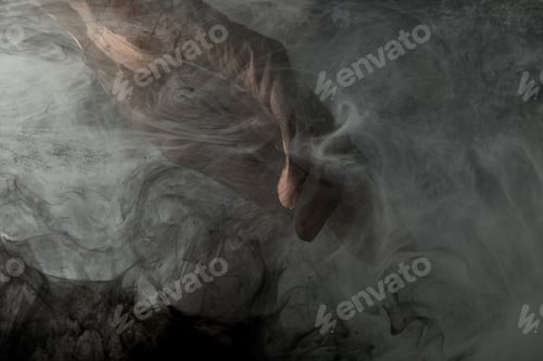 Preview: partial view of male hand in grey smoke