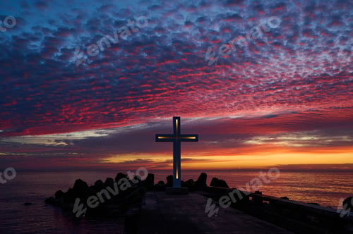 Preview: Christian Holy cross early in the morning at sunrise. The large cross stands on the edge of a
