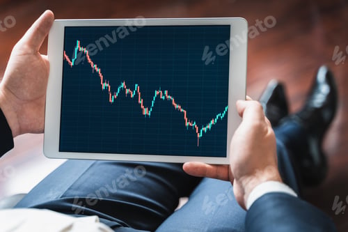 Preview: Businessman, investor,trader analyzing,looking at chart of stock prices in tablet. CEO,general manag