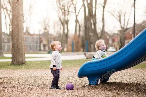 Preview: Brothers playing on slide