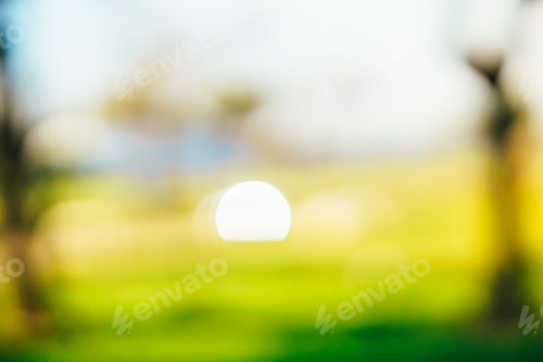 Preview: background of the glare of a car crossing the field