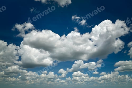Preview: White puffy cumulus clouds on summer blue sky