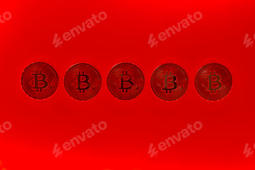 Preview: Bitcoin coins in horizontal row on red background. Cryptocurrency