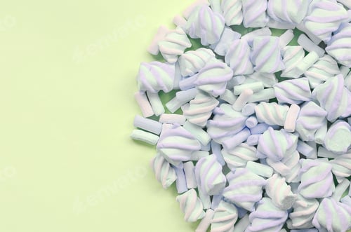 Preview: Colorful marshmallow laid out on lime paper background. pastel creative texture
