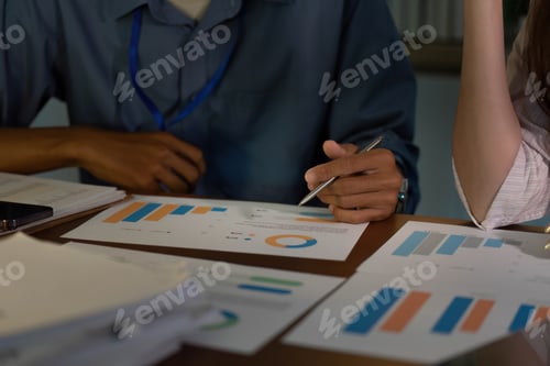 Preview: Team Collaboration in Office. Professionals analyzing financial reports together.
