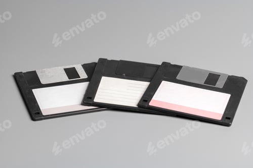 Preview: Three old computer diskette over grey background