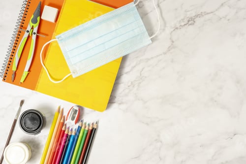 Preview: Sanitary mask, colored pencils, notebooks, compass, brush, rub on a marble table