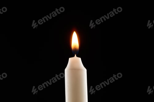 Preview: burning white candle glowing isolated on black