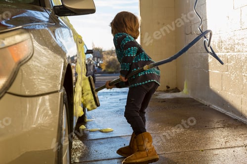 Preview: 4 year old boy washing a car in car wash