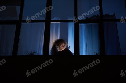 Preview: Girl Using Smartphone while Sitting on Window at Night