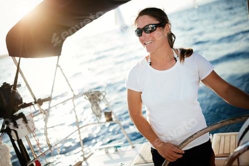 Preview: Attractive strong woman sailing with her boat