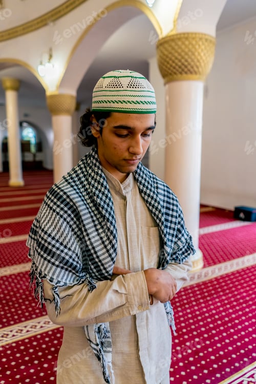 Preview: A young Muslim man in national Arabic clothing prays in a mosque during the Ramadan holiday