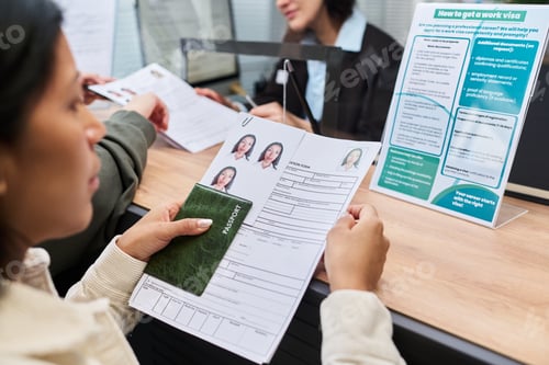 Preview: Young Adult Woman Submitting Visa Application Documents at Visa Center Counter